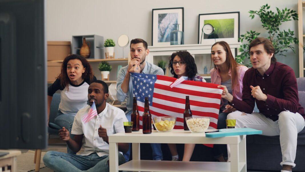 unsplash-788-1752684766 a group of people sitting on a couch holding an american flag